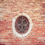 Wrought Iron Windown in an Ancient BWrought Iron Window in an Ancient Brick Wall, Venice, Italyrick Wall, Venice, Italy